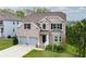 Beautiful two-story brick home with a two-car garage and well-maintained lawn at 3540 Lindsy Brook, Douglasville, GA 30135