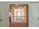 View of the upstairs hallway through a doorway with the banister and windows ahead at 3540 Lindsy Brook, Douglasville, GA 30135