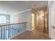 Second floor hallway featuring spindled railings, an arched window and hardwood floors at 3540 Lindsy Brook, Douglasville, GA 30135