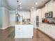 Beautiful kitchen features white cabinets, granite countertops, modern appliances, and center island with sink and seating at 3540 Lindsy Brook, Douglasville, GA 30135