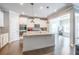 This modern kitchen is equipped with an island, white cabinets, stainless appliances, and granite countertops at 3540 Lindsy Brook, Douglasville, GA 30135