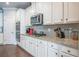 Bright kitchen with white cabinets, stainless appliances, granite countertops, subway backsplash and gas cooktop at 3540 Lindsy Brook, Douglasville, GA 30135