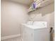 A laundry room featuring a full sized washer and dryer and a shelf for storage at 3540 Lindsy Brook, Douglasville, GA 30135