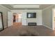 Open main bedroom with access to second floor, a television and an electric fireplace at 3540 Lindsy Brook, Douglasville, GA 30135