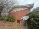 Exterior corner view of a brick home showing an exterior utility area at 1789 Riverridge Nw Dr, Conyers, GA 30012