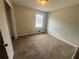 Bedroom with neutral walls, carpet flooring and a window providing natural light at 1789 Riverridge Nw Dr, Conyers, GA 30012