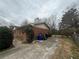 Brick house with driveway, trash cans, and front yard bushes on an overcast day at 1789 Riverridge Nw Dr, Conyers, GA 30012