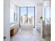 Luxurious bathroom featuring marble floors, soaking tub, double vanity, and a stunning city view at 2425 Peachtree Nw Rd # 1802, Atlanta, GA 30305