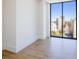 Bright bedroom with sleek wood floors, expansive windows, and a beautiful city view at 2425 Peachtree Nw Rd # 1802, Atlanta, GA 30305