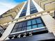 Modern condominium building featuring architectural design, visible signage, and multiple private balconies at 2425 Peachtree Nw Rd # 1802, Atlanta, GA 30305