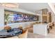 Entertaining game room featuring a poker table, bar seating, and multiple large screen televisions at 2425 Peachtree Nw Rd # 1802, Atlanta, GA 30305