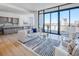 Open concept with spacious living room featuring floor-to-ceiling windows and modern kitchen at 2425 Peachtree Nw Rd # 1802, Atlanta, GA 30305