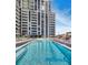 Large outdoor pool with stylish lounge seating and scenic views of the surrounding high-rise building at 2425 Peachtree Nw Rd # 1802, Atlanta, GA 30305