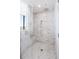 Modern walk-in shower with marble tile surround, glass enclosure, and a rainfall showerhead at 2425 Peachtree Nw Rd # 1802, Atlanta, GA 30305