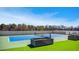 Bright tennis court with blue and green surface and lush surrounding landscaping on a sunny day at 2425 Peachtree Nw Rd # 1802, Atlanta, GA 30305