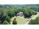 Aerial view of the home surrounded by lush greenery, showcasing its serene setting at 8440 Woodland Brooke Trl, Cumming, GA 30028