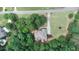 Aerial perspective of the home nestled in a private, wooded lot with mature trees at 8440 Woodland Brooke Trl, Cumming, GA 30028