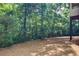 Wooded, green backyard features privacy and a peaceful place to enjoy nature at 8440 Woodland Brooke Trl, Cumming, GA 30028