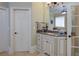 Bright bathroom featuring granite countertops and custom cabinets at 8440 Woodland Brooke Trl, Cumming, GA 30028