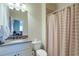 Neutral bathroom with granite sink, toilet and tub/shower combo with curtain at 8440 Woodland Brooke Trl, Cumming, GA 30028