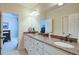 Bathroom featuring double sinks, granite countertops, and white cabinets offering ample storage at 8440 Woodland Brooke Trl, Cumming, GA 30028