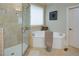 Bright bathroom featuring a glass enclosed walk-in shower and a soaking tub with tile surround at 8440 Woodland Brooke Trl, Cumming, GA 30028