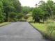 Scenic community entrance with gazebo and a park sign at 8440 Woodland Brooke Trl, Cumming, GA 30028