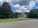 Beautiful two-story home boasting a well-manicured lawn and mature trees at 8440 Woodland Brooke Trl, Cumming, GA 30028