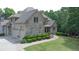 Attractive brick home featuring well-maintained landscaping and an attached garage at 8440 Woodland Brooke Trl, Cumming, GA 30028