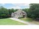 Beautiful two-story home featuring brick exterior, well-kept lawn, and attached garage at 8440 Woodland Brooke Trl, Cumming, GA 30028