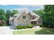Stunning two-story brick home with manicured landscaping and a three-car garage at 8440 Woodland Brooke Trl, Cumming, GA 30028