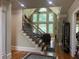 Open foyer with hardwood floors, staircase, and large windows that provide abundant natural light at 8440 Woodland Brooke Trl, Cumming, GA 30028