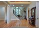 Grand foyer with hardwood floors, a staircase, and elegant architectural details at 8440 Woodland Brooke Trl, Cumming, GA 30028