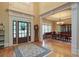 Inviting foyer with hardwood floors, a patterned rug, and view into the dining room at 8440 Woodland Brooke Trl, Cumming, GA 30028