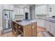 Open kitchen with stainless appliances and island at 8440 Woodland Brooke Trl, Cumming, GA 30028