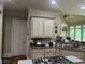 Well-lit kitchen featuring granite countertops, custom cabinets, and stainless steel appliances at 8440 Woodland Brooke Trl, Cumming, GA 30028