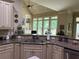 Well-appointed kitchen with granite countertops, custom cabinets, and open view to the deck at 8440 Woodland Brooke Trl, Cumming, GA 30028