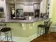 Open kitchen with seating at the island and stainless appliances at 8440 Woodland Brooke Trl, Cumming, GA 30028
