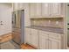 This kitchen features stainless steel appliances, granite countertops, and classic-style cabinetry at 8440 Woodland Brooke Trl, Cumming, GA 30028