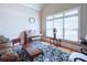 Cozy living room space with a piano and comfortable seating area next to the window at 8440 Woodland Brooke Trl, Cumming, GA 30028