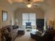 Cozy living room with a ceiling fan, comfortable seating, and a television at 8440 Woodland Brooke Trl, Cumming, GA 30028