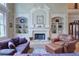 Bright living room with fireplace and built-in bookshelves at 8440 Woodland Brooke Trl, Cumming, GA 30028
