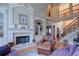 Spacious living room featuring a fireplace and built-in bookshelves at 8440 Woodland Brooke Trl, Cumming, GA 30028