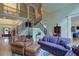 Spacious living room featuring a staircase to the second floor at 8440 Woodland Brooke Trl, Cumming, GA 30028