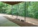 Covered patio with concrete floor and direct access to green backyard space at 8440 Woodland Brooke Trl, Cumming, GA 30028