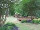 Scenic playground view with a bridge, set amongst lush greenery for an active outdoor space at 8440 Woodland Brooke Trl, Cumming, GA 30028