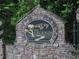 Stone entrance to The Legends of Settendown Creek community with elegant signage at 8440 Woodland Brooke Trl, Cumming, GA 30028