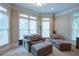 Relaxing sitting area with soft chairs and natural light streaming through large windows at 8440 Woodland Brooke Trl, Cumming, GA 30028