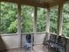 Bright sunroom with views of lush trees at 8440 Woodland Brooke Trl, Cumming, GA 30028