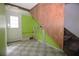 A basement featuring a door to the exterior, painted green walls, and checkerboard flooring leading to a staircase at 4011 Florida Ave, Atlanta, GA 30360